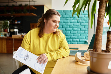 Young woman with Down syndrome enjoys a casual cafe day while browsing the menu with confidence