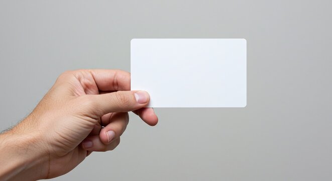 Hand Holding Card: A hand presenting a blank card, perfect for showcasing information or design elements. conveying a sense of simplicity and clarity. 
