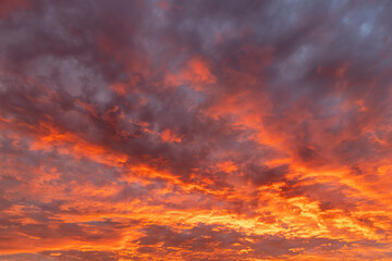 Beautiful sunset sky with multicolored clouds of different sizes