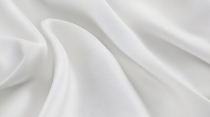 Obraz premium White silk fabric forming soft folds and waves, creating elegant curves