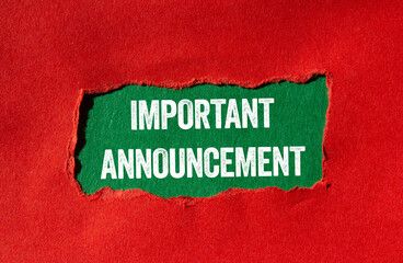 Important announcement message written on ripped torn red paper on green background. Conceptual important announcement symbol. Copy space.