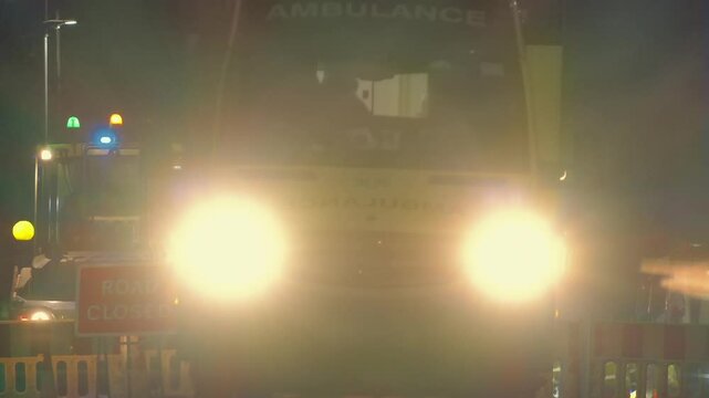 Road Works With Ambulance Passing At Night
