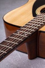 Fototapeta premium Classical guitar close up. Acoustic guitar on wood background.Music instrument concept