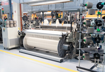 Industrial fabric production line. Looms in a textile factory