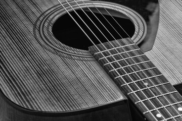 Obraz premium Classical guitar close up. Acoustic guitar on wood background.Music instrument concept