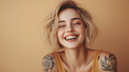 Smiling blond pretty happy girl beauty female generation z tattooed model with short blonde hair beautiful face healthy skin looking at camera laughing isolated at beige background. Aesthetic portrait