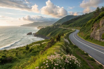 A scenic coastal highway winding through lush green hills, offering breathtaking ocean views under a vibrant sunset sky.