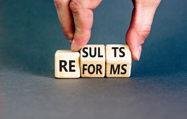 Reform and result symbol. Concept words Reforms Results on beautiful wooden block. Beautiful grey...