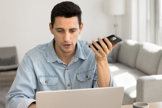 Man lead conversation using speakerphone, engaged in formal communication on smartphone, participating in work-related activity, or seeking information, browsing internet, make commands through AI app