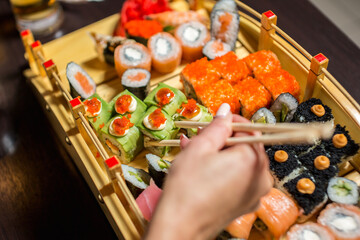Assorted sushi rolls on a serving stand