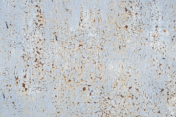 Rusty metal surface with peeling white paint. Texture rusty metal. Abstract background for design.