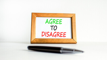 Agree to disagree symbol. Concept words Agree to disagree on beautiful wooden picture frame. Black...