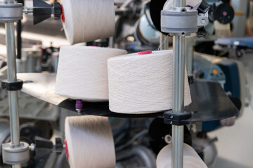 large bobbins of thread in a weaving factory