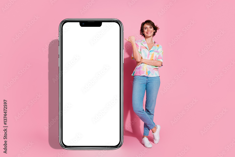 Poster full size photo of pretty young lady point finger empty space smart phone screen isolated on pink co