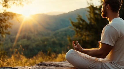 A man sits peacefully in meditation, embracing the tranquility of nature as the sun rises over the mountains, promoting calmness, well-being, and mindfulness in this serene environment.