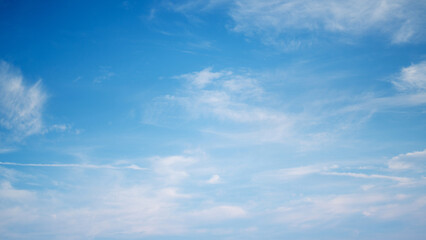 The sky is a vibrant, cloudless blue, while the sun shines brightly, making it appear even more radiant.