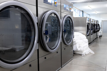 Laundromat laundry service. Washing and drying machine in a row.
