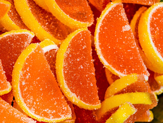 Sparkling Orange Jelly Slices. Macro Photography of Sugar-Crystallized Fruit-Shaped Candies. Vibrant Party Confections in Glistening Detail