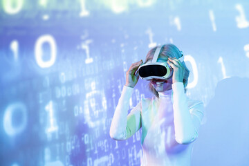 Cheerful elderly asian woman exploring the metaverse with VR headset