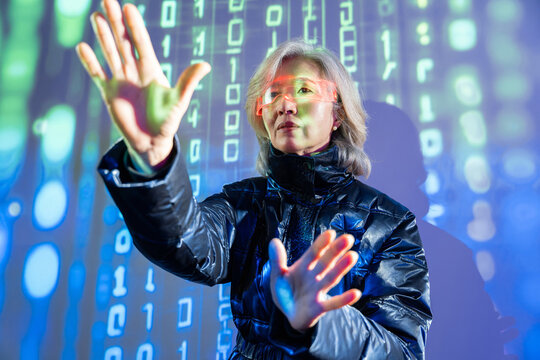 Elderly asian woman exploring virtual reality in metaverse