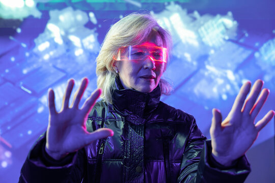Elderly asian woman exploring virtual reality in metaverse