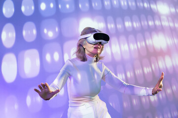 Elderly asian woman exploring the metaverse with VR headset