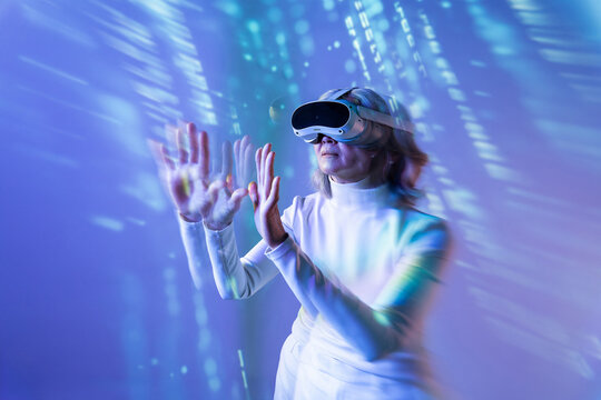 Elderly asian woman exploring the metaverse with VR headset