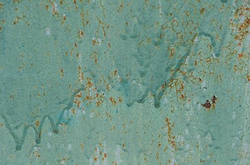 Weathered green surface with peeling paint and rust marks reveals a vintage aesthetic reminiscent...