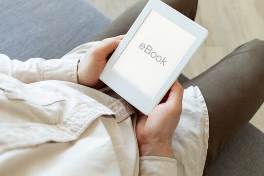 Man reading ebook. Modern digital e-book tablet with electronic ink technology for relaxation, education and business.