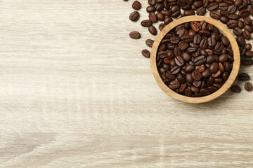 Coffee beans in a bowl on wooden background