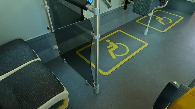 Interior of a Public Bus with Designated Seating for Disabled and Pregnant Passengers, Featuring Accessibility Features