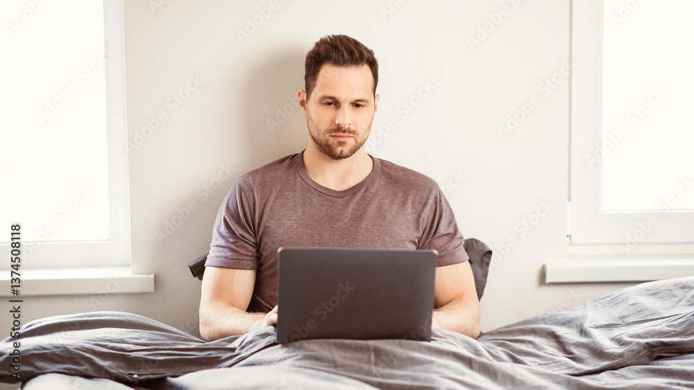 Aufkleber Man Working On Laptop Online, Browsing Internet Sitting In Bed At Home. Freelancer Using Computer In Bedroom. Freelance Career Lifestyle And Distant Job Concept. Panorama