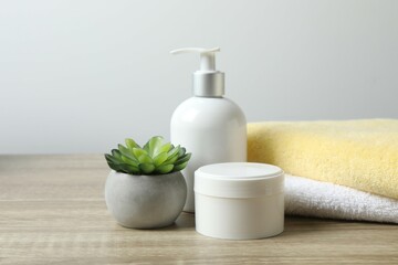 Stack of bath towels and cosmetics on the table