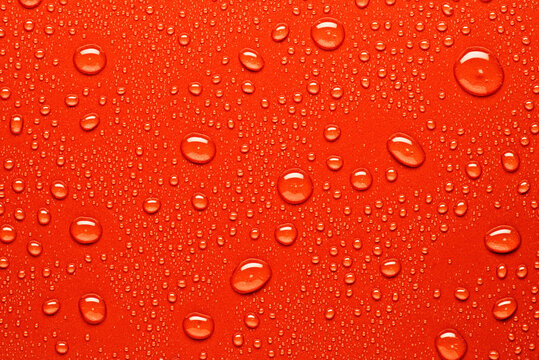 Water droplets on vibrant red surface with texture - Powered by Adobe