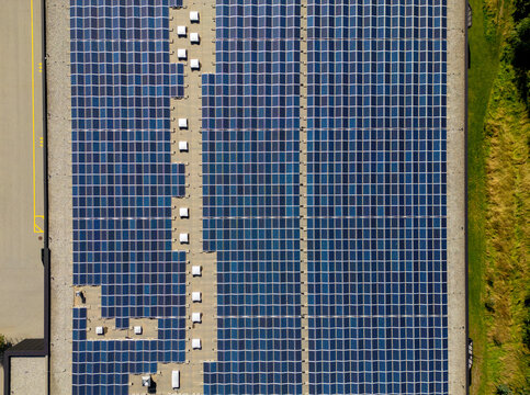 Aerial View of Solar Panel Array in Swiss Landscape