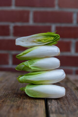Raw organic Belgian endive ready to use on wooden table