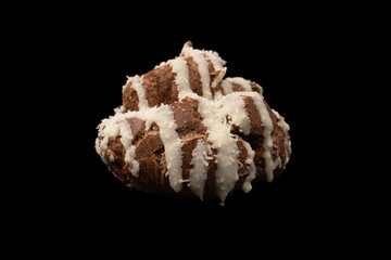 Profiteroles with coconut cream on a black background.