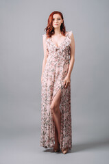 Summer frill maxi dress in floral design with plunge neckline and thigh split. Beautiful redhead...