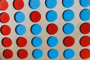 Wooden board with red and blue circles, creating a simple abstract composition with geometric shapes