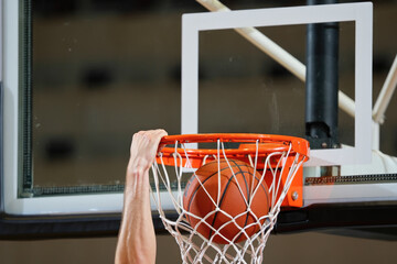 Basketball dunk close-up hand gripping hoop ball scoring athletic action
