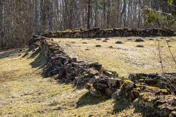 old partially ruined wall made of granite boulder rocks and field stones