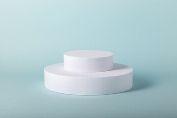 Showcase props for online marketing. Minimal concept with white round stands on blue background.