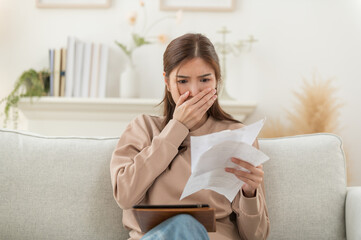 Asian woman feeling unhappy after looking at the bill feels stressed having financial problem,...