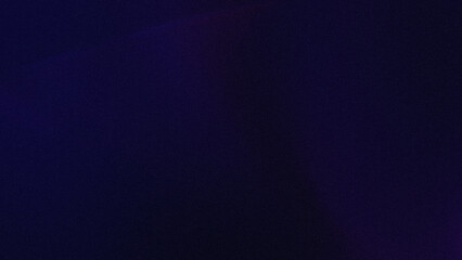 A dark and blurry image showing a gradient of dark blue and purple colors with soft transitions visible