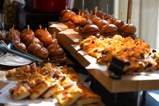 Lunch time on a big event, buffet with mini burgers and pizza