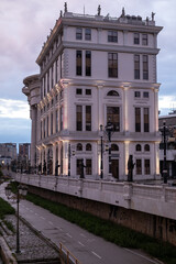 Naklejka premium Ornate White Building by the River at Dusk