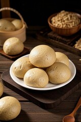 there are a plate of bread rolls on a wooden table
