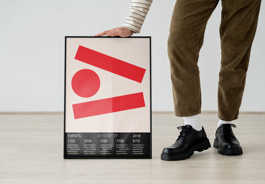 Mockup Of Man Leaning On Framed Customized Poster