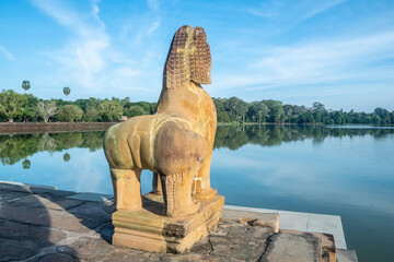 Angkor Wat, A remarkably tall building set against a clear blue sky backdrop