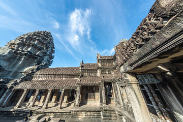 Angkor Wat, A remarkably tall building set against a clear blue sky backdrop